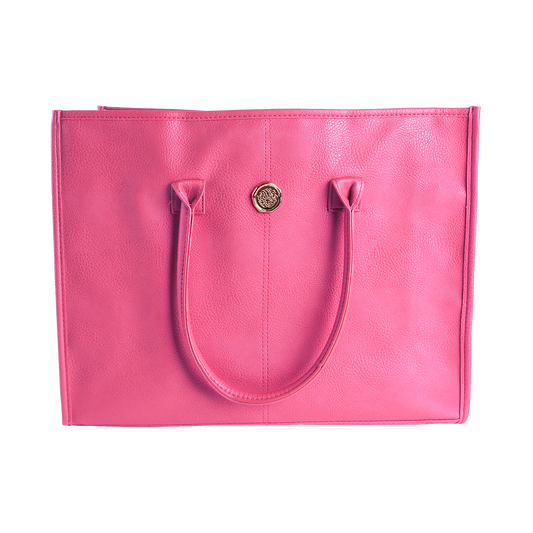 The Raspberry Pink Tote Bag, crafted from bright pink faux leather, features two handles and a small round gold emblem on the front, shown against a plain white background.