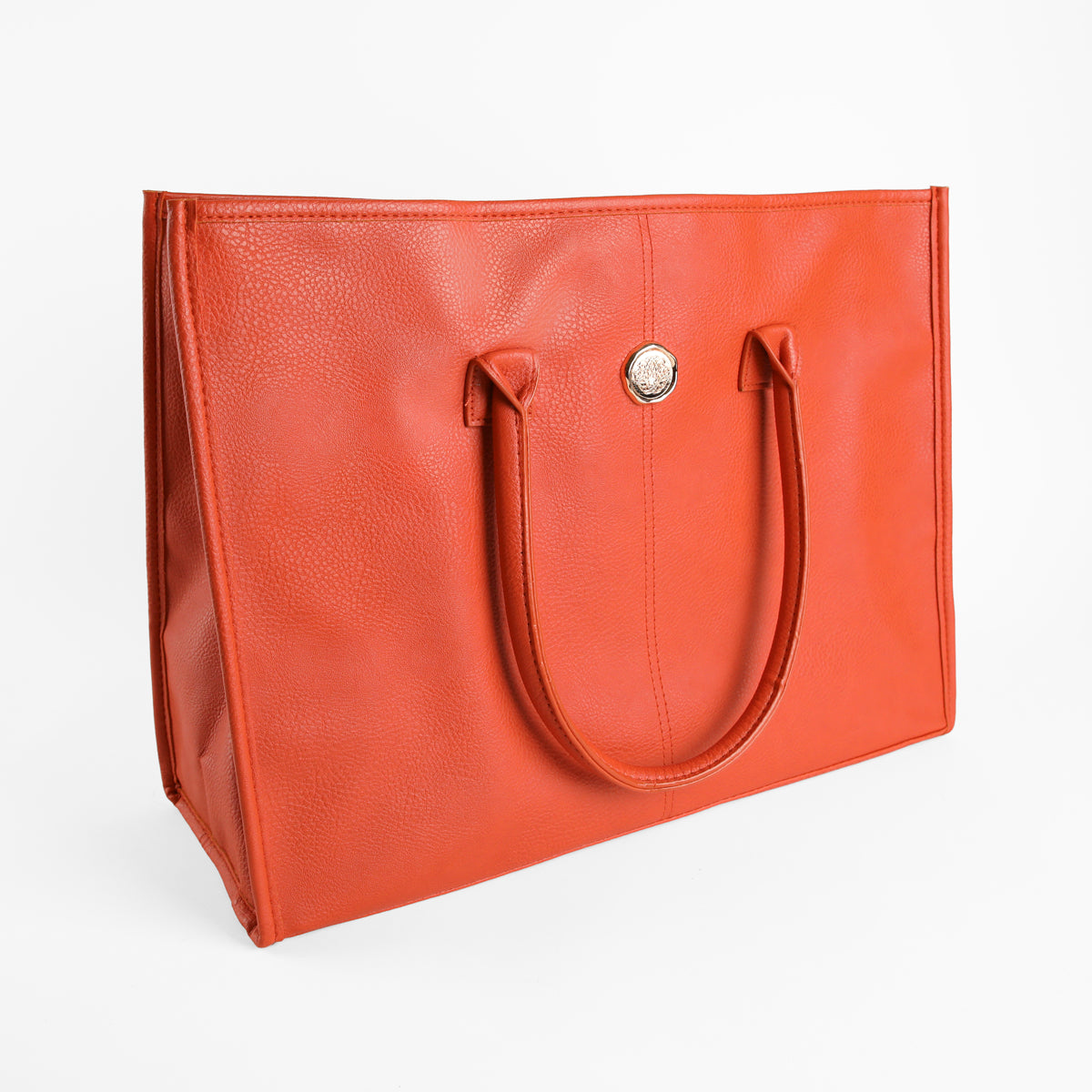 Tangerine Orange Tote Bag for women, featuring faux leather material, double handles, and a circular metal emblem on the front, displayed on a white background.