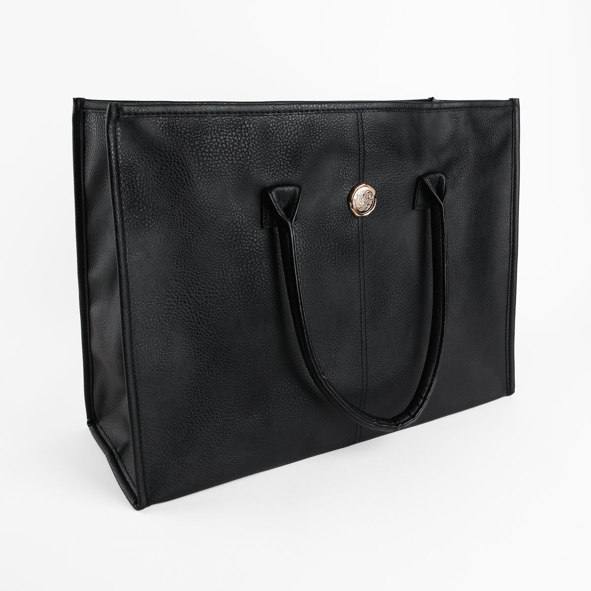 The Onyx Black Tote Bag is a large faux leather tote featuring two handles and a circular gold emblem on the front, presented against a plain white background.
