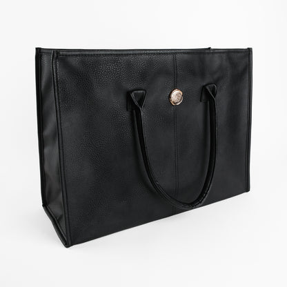 The Onyx Black Tote Bag is a large faux leather tote featuring two handles and a circular gold emblem on the front, presented against a plain white background.