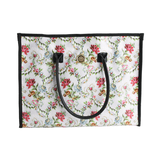Introducing the Phoebe Tote Bag—a standout large tote for women featuring a vibrant, colorful floral pattern. Designed with black handles, sleek black trim, and a gold circular emblem near the top center, this stylish everyday shoulder bag effortlessly combines function and flair.