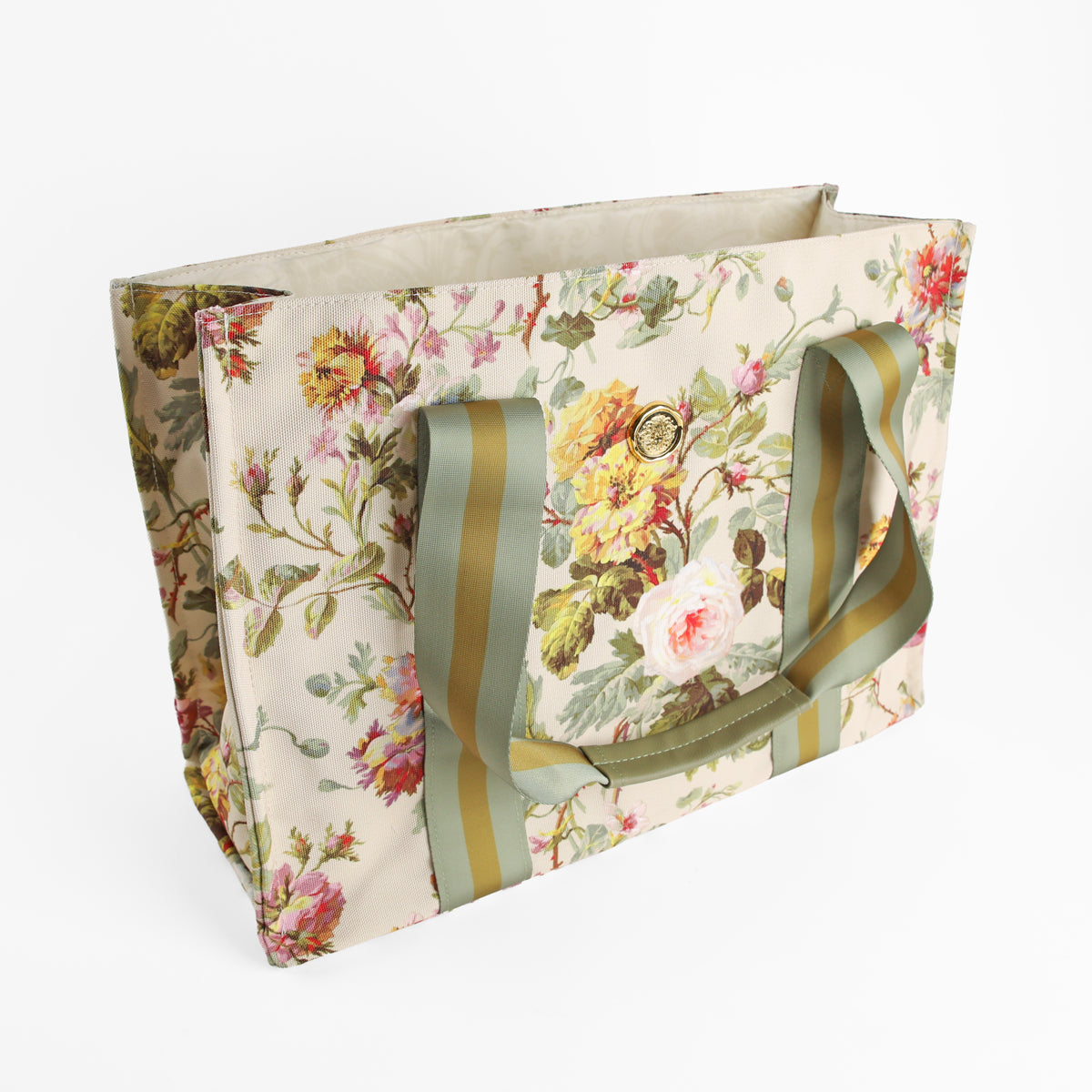 Introducing the Francesca Tote Bag: a large rectangular canvas tote featuring green handles and a charming floral print with pink, yellow, and white flowers on a cream background. Set against a crisp white backdrop, this stylish botanical market bag is perfect for everyday errands or visits to the farmer’s market.