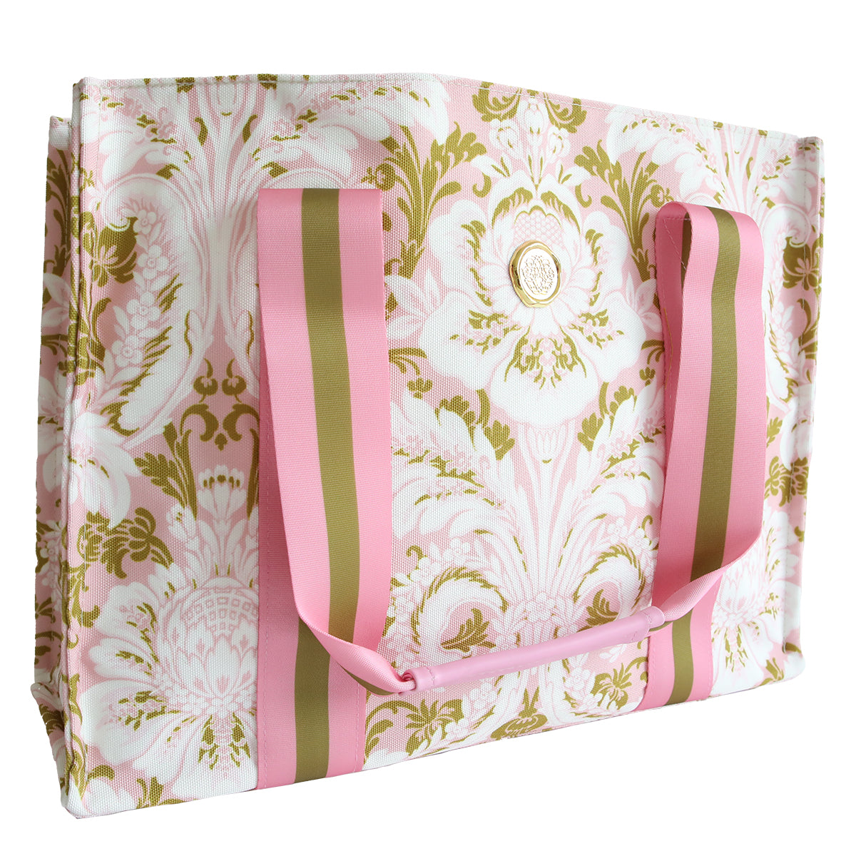 The Pink Damask Tote Bag features a pink and gold floral pattern, matching striped handles, a round gold emblem on the front, and is made from durable cotton—perfect for everyday use.