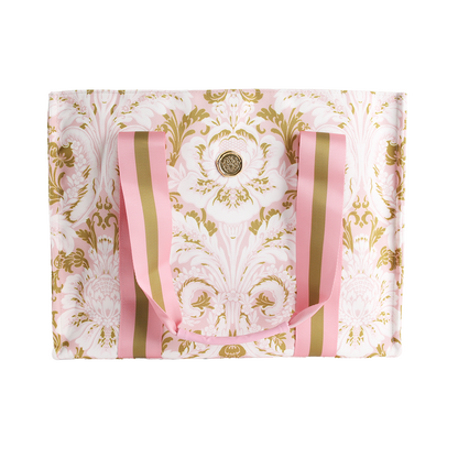 Introducing the Pink Damask Tote Bag: an elegant large canvas tote adorned with a pink and gold baroque floral pattern. This stylish bag features pink and gold striped handles and is accented by a circular gold emblem at its center, making it the perfect choice for a floral market trip or elevating your everyday look with a touch of luxury.
