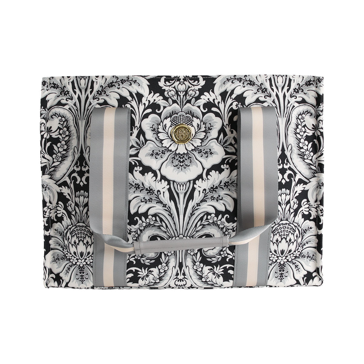 The Damask Noire Tote Bag features an ornate black and white floral damask pattern on a rectangular silhouette, complemented by vertical gray and cream straps and a central gold decorative button.