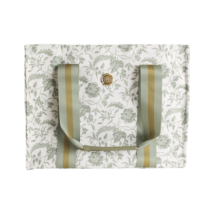 Green Climbing Rose Tote Bag—white canvas market bag featuring a green climbing rose floral pattern, gold and green striped handles, and a round gold button closure at the center; a charming floral tote perfect as a botanical gift for women.