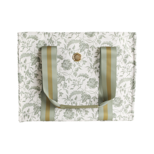 Green Climbing Rose Tote Bag—white canvas market bag featuring a green climbing rose floral pattern, gold and green striped handles, and a round gold button closure at the center; a charming floral tote perfect as a botanical gift for women.