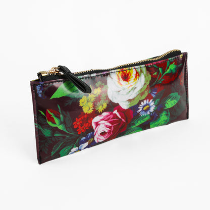 Astrid Pencil Case with a vibrant botanical print of roses and various flowers on a dark background, photographed on a white surface.