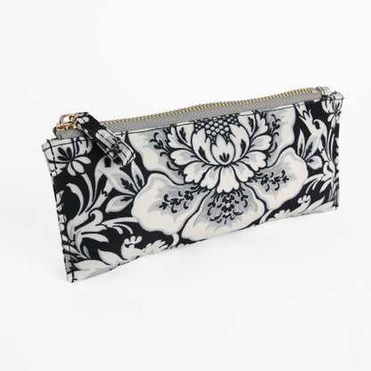 Damask Noire Pencil Case, a rectangular zippered pouch featuring a black and white damask floral pattern on fabric, displayed against a white background. This elegant pencil case effortlessly combines functionality with chic style, making it perfect for organizing your stationery.