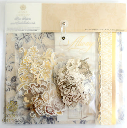 A packaged set of Faded Rose Papers and Embellishments from Anna Griffin. This set includes floral designs in shades of beige, gold, and white, perfect for adding a touch of elegance to any project.