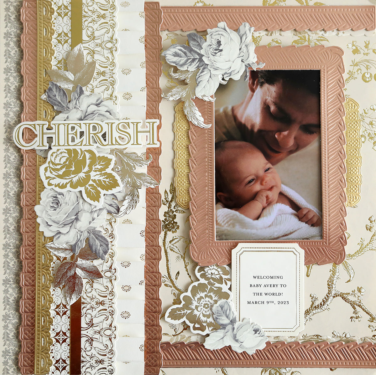 A scrapbook page with Faded Rose Papers and Embellishments showcasing a photo of an adult and a baby. The page has text reading "CHERISH" and a note stating "Welcoming Baby Avery to the world - March 9th, 2023.