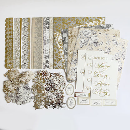 A selection of decorative paper items including Faded Rose Papers and Embellishments, die-cut embellishments, and printed phrases like "Cherish" and "Dream Memories" in shades of gold, silver, and neutral colors. Perfect for adding scrapbook embellishments to your projects.