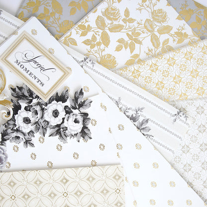 A stack of white and gold papers used for Anna Griffin | Create Crop At Home 4 scrapbooking event.