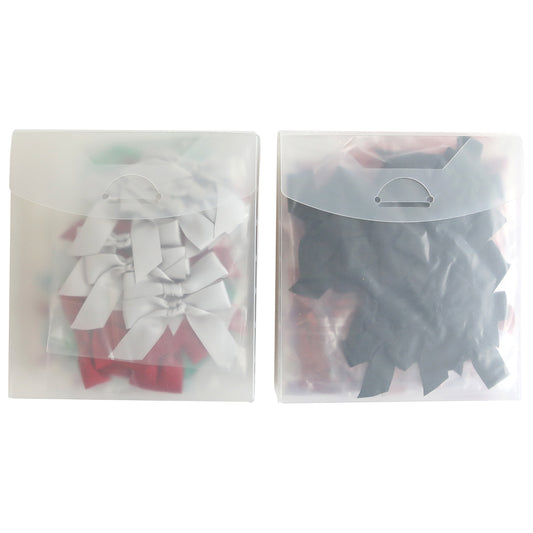 Two transparent plastic storage boxes, each filled with pre-tied handmade bow sets from the Falloween and Christmas collection. The left box features predominantly white and red Christmas bows, while the right box is primarily stocked with black Halloween bows.