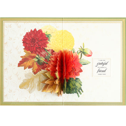 An open greeting card from the Folded Fall Card Making Kit, adorned with 3D red, yellow, and orange flowers and leaves, featuring a heartfelt message that reads "I am so grateful to have a friend like you." This kit ensures each creation is unique and beautiful.