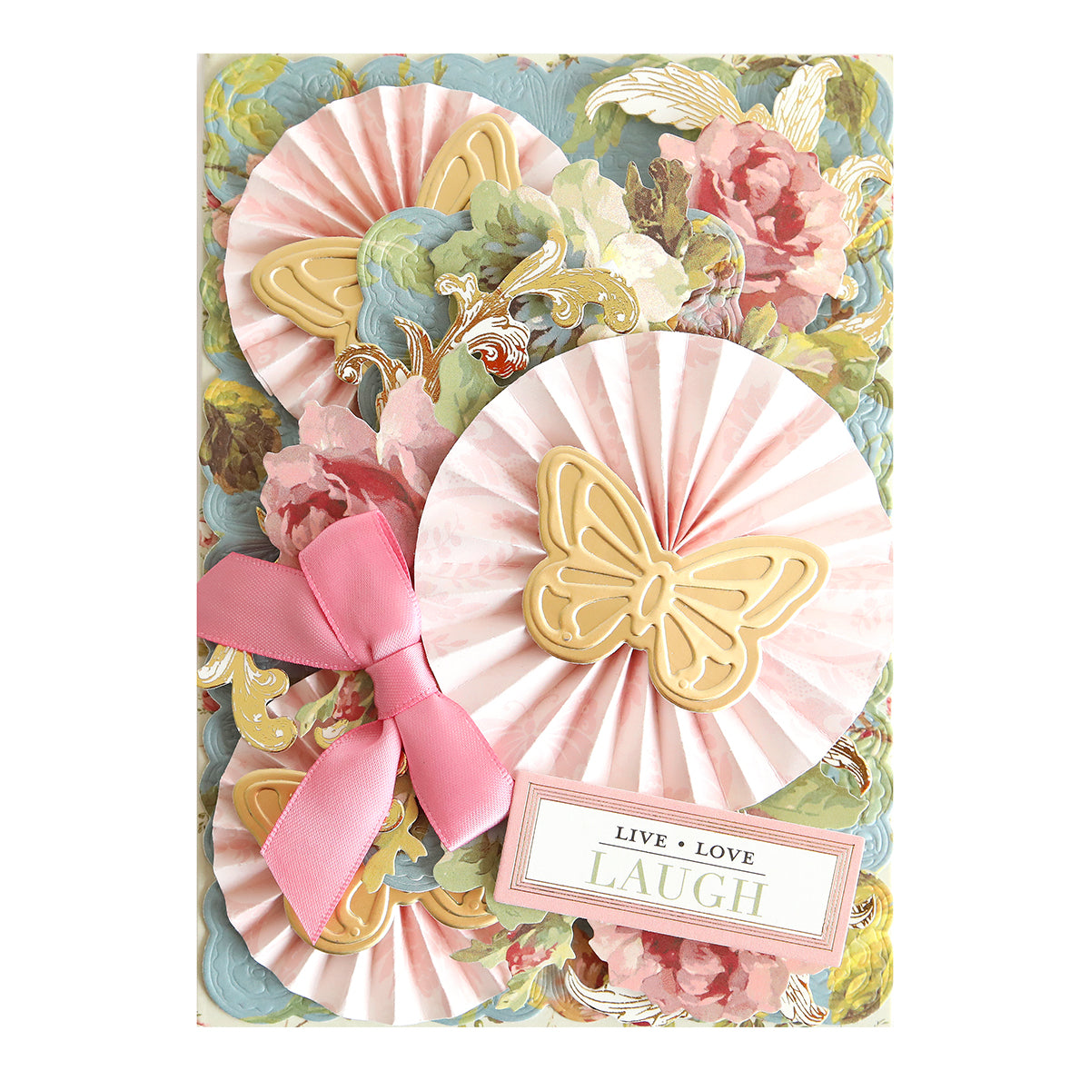 Decorative greeting card showcasing pink rosettes, gold butterfly accents, a pink bow, and a floral background enhanced with floral rub on transfers from the Ultimate Francesca Papercrafting Collection with Rub Ons. Features a tag that reads “Live Love Laugh,” making it an elegant addition to your scrapbook supplies.