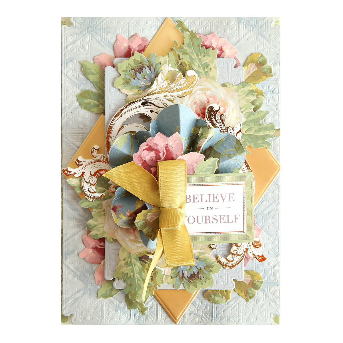 Greeting card adorned with floral decorations, gold accents, and a yellow ribbon, featuring “BELIEVE IN YOURSELF” on the front—an ideal addition to your scrapbook supplies or for pairing with floral rub on transfers from the Ultimate Francesca Papercrafting Collection with Rub Ons.