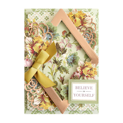 A floral greeting card with a gold frame, yellow ribbon bow, and a plaque reading "Believe in Yourself" on the bottom right.