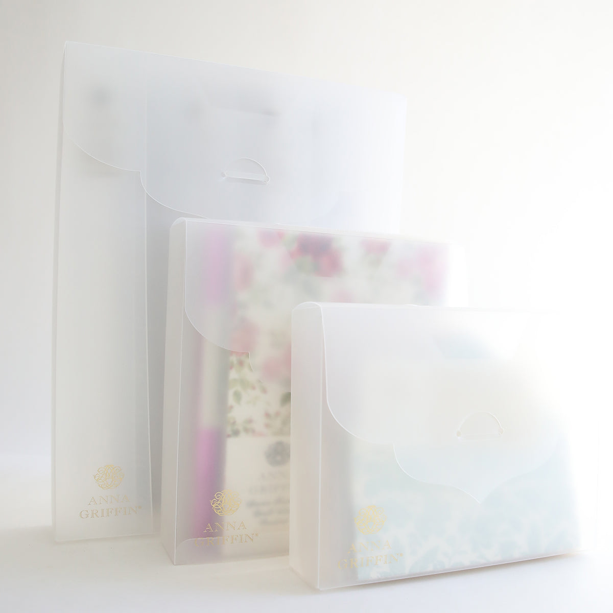 Three Frosted Craft Storage Boxes 9 count for craft storage on a white surface.