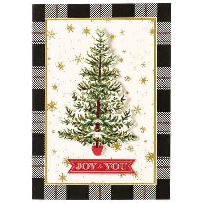 The Tree Black Plaid Boxed Card features a beautiful Christmas card displaying a decorated tree in a red pot, adorned with a "Joy to You" banner. The backdrop is embellished with gold snowflakes, framed by an elegant black-and-white plaid pattern. This exquisite card is one of our handmade holiday creations, boasting specialty finishes that make it truly unique. Available as part of our 10-count boxed set.