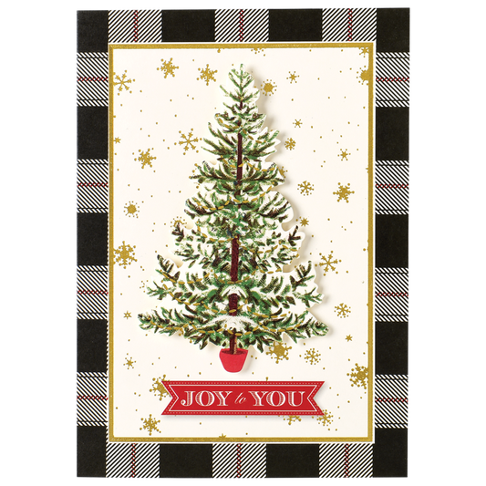 The Tree Black Plaid Boxed Card features a beautiful Christmas card displaying a decorated tree in a red pot, adorned with a "Joy to You" banner. The backdrop is embellished with gold snowflakes, framed by an elegant black-and-white plaid pattern. This exquisite card is one of our handmade holiday creations, boasting specialty finishes that make it truly unique. Available as part of our 10-count boxed set.