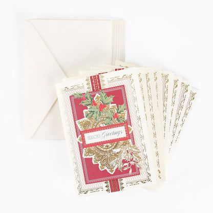 A box of 10 Gilded Filigree holiday cards featuring elegant red and gold designs with “Season’s Greetings” text, paired with matching cream envelopes and displayed on a white surface.