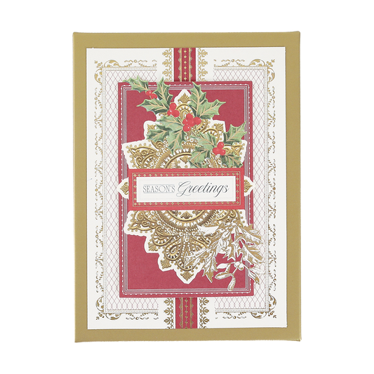 The Gilded Filigree Boxed Cards 10 ct features a festive design with holly leaves and red berries, accented with elegant gold detailing reminiscent of classic gilded holiday cards, and showcases the text “Season’s Greetings” on a bold red and white background.