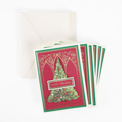 Set of ten elegant Cathedral Christmas Tree Boxed Cards, each featuring a beautifully decorated tree and “Merry Christmas” text in red, displayed with matching white envelopes on a white background—perfect for sharing holiday cheer this season.