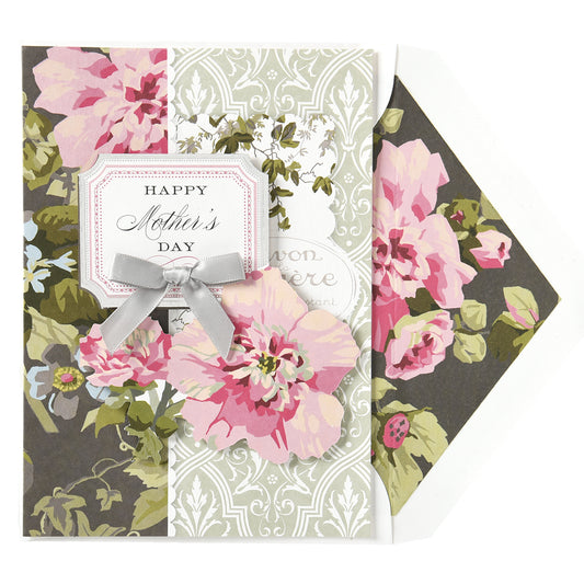 The Camilla Happy Mother's Day Card, adorned with pink flowers and gold foil accents, features a silver ribbon bow and comes with a printed lined envelope. This elegant 5" x 7" card makes for a memorable expression of love.