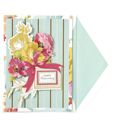 The Rose Anniversary Card features a floral design, elegant gold foil "Happy Anniversary" text, and bow, with a light blue printed lined envelope.