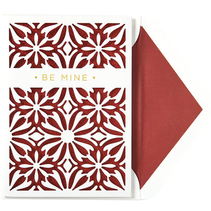 The Be Mine Laser Cut Single Card showcases intricate red floral cutouts and "Be Mine" in gold foil. It includes a matching printed lined envelope with the vibrant red design.