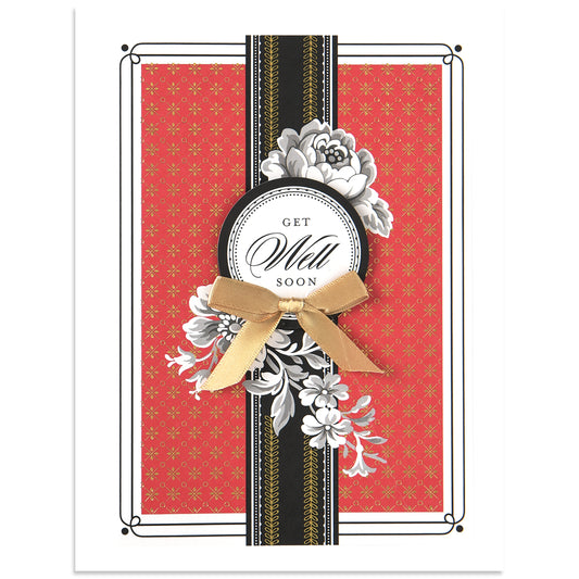 The "Delphine Get Well Soon Card" has a red patterned background, black and gold foil stripes, a white floral design, and a gold bow. It comes with an elegantly coordinated printed lined envelope.