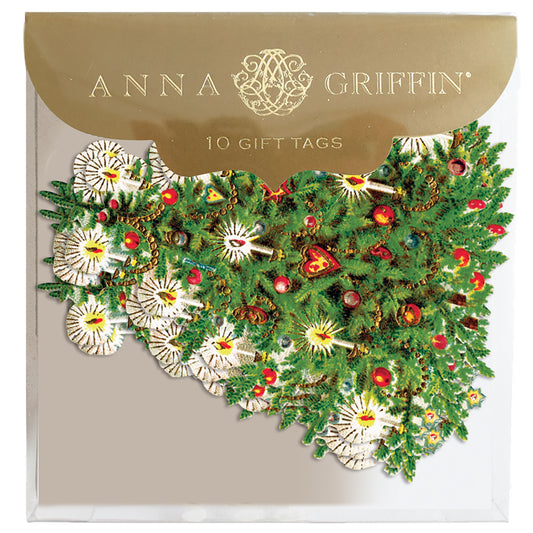 A pack of Yuletide Tree Tag 10 ct, from Anna Griffin, featuring a festive holiday design with green foliage and decorative elements, enclosed in transparent packaging with a gold label at the top.