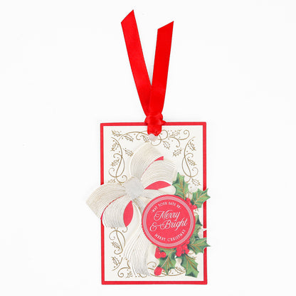Add festive charm to your Christmas gift tags collection with the Heirloom Holly Tag 10 ct—a set of rectangular holiday gift tags featuring a red ribbon, gold bow, holly leaves, and a cheerful “Merry & Bright” greeting on a red circle.