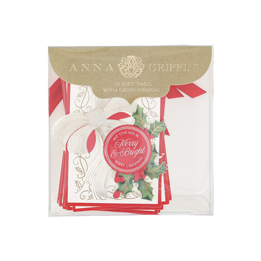 A package of Heirloom Holly Tag 10 ct by Anna Griffin includes 10 Christmas gift tags with satin ribbon, featuring a festive holly design, a white bow, and “Merry & Bright” text.