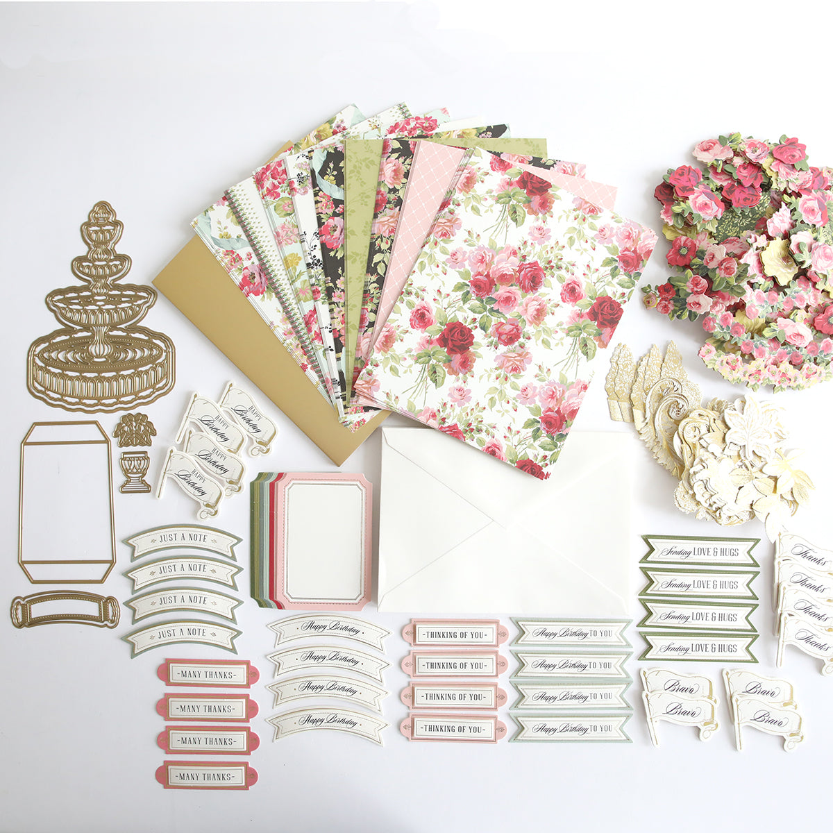 An Anna Griffin craft box filled with a collection of interactive Garden Fountain Easel Finishing School Kit cards, papers, and flowers for creative enthusiasts.