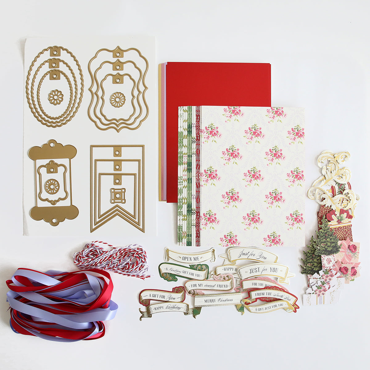 A customizable Christmas card kit with handmade and custom tags, adorned with ribbons. The Anna Griffin Gift Tag Compendium Class Materials and Dies, the perfect gift for the holiday season.