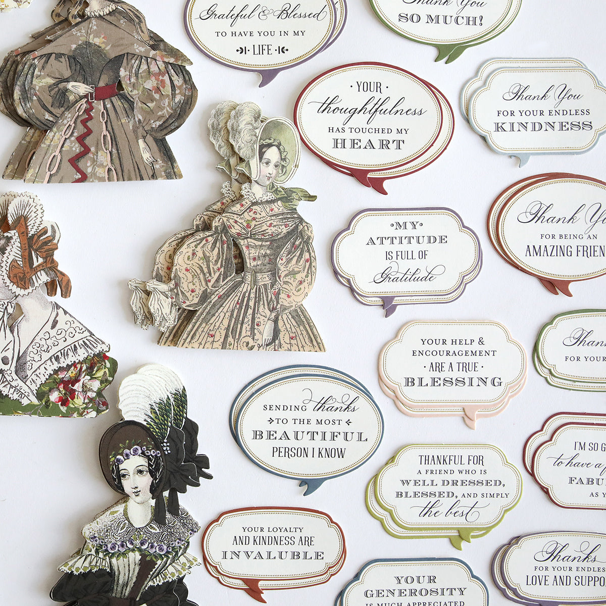 Grateful Paper Doll Stickers and Sentiment Diecuts featuring Victorian ladies in vintage clothing and various decorative plaques with phrases expressing gratitude and appreciation, arranged on a white background.