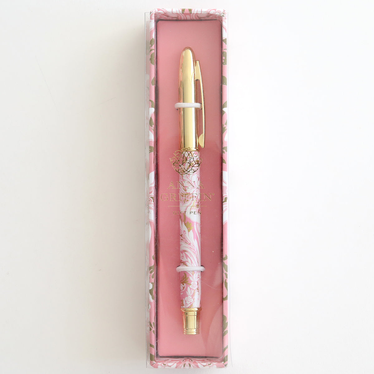 The Pink Damask Gift Pen, a decorative ballpoint with a gold and pink pattern, comes elegantly presented in a floral-themed box with a clear lid, making it the perfect accessory for any stationery enthusiast.