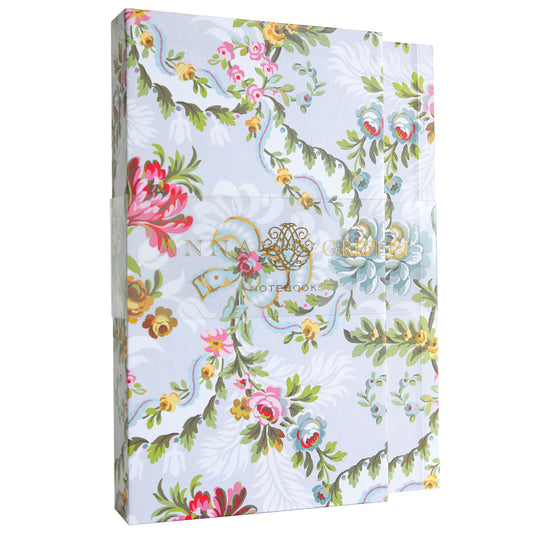 Phoebe Floral Notebook Set with a partial view of a golden emblem on the cover.