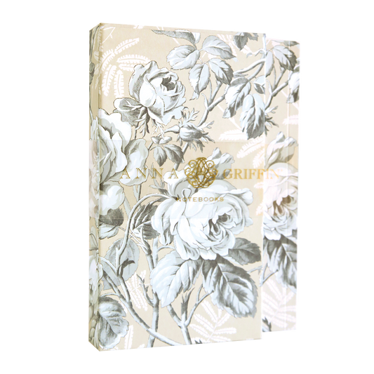 The Faded Rose Notebook Set features a beige and gray floral design with large white roses and green leaves. Branded "Anna Griffin" in gold foil, it offers lined pages for all your writing needs.