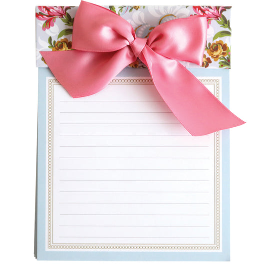 Phoebe Floral Bow Pad with a pink satin bow on floral background.