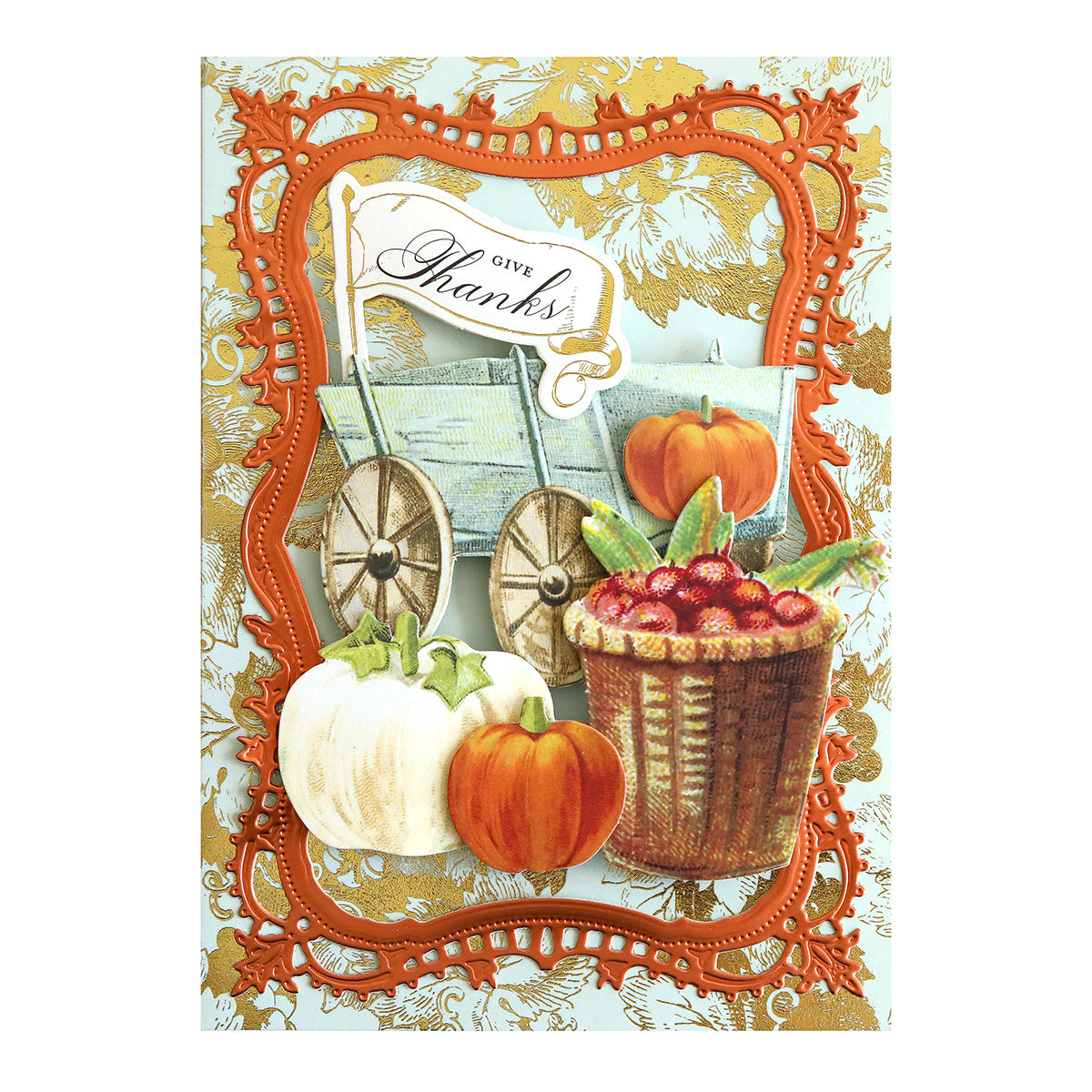 Greeting card featuring Harvest Embellishment Stickers, a “Give Thanks” sign, a wooden cart, pumpkins, a basket of cranberries, and an ornate orange frame set against a gold floral patterned background—beautifully finished with charming dimensional details.