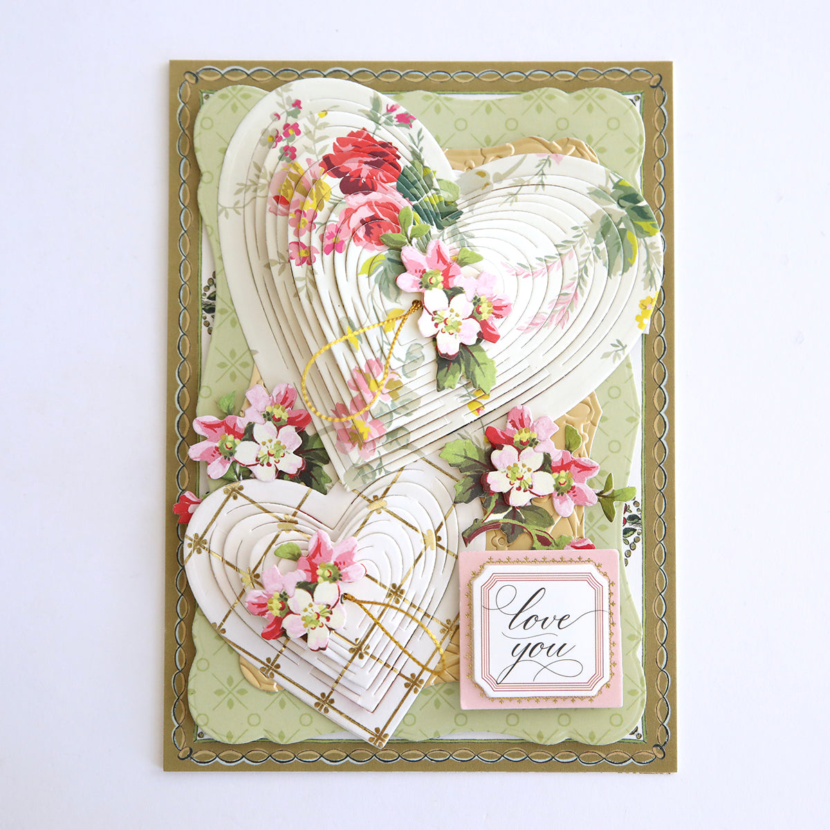 A delicate valentine's day card inspired by the Japanese technique, featuring hearts and flowers made with Heart Kirigami Dies.