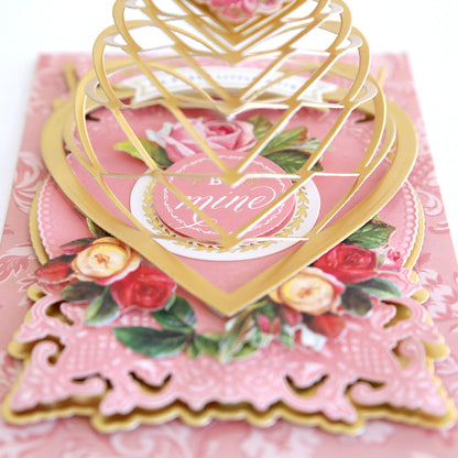 A delicate and Japanese inspired pink and gold card with a heart on it created using the Heart Kirigami Dies.