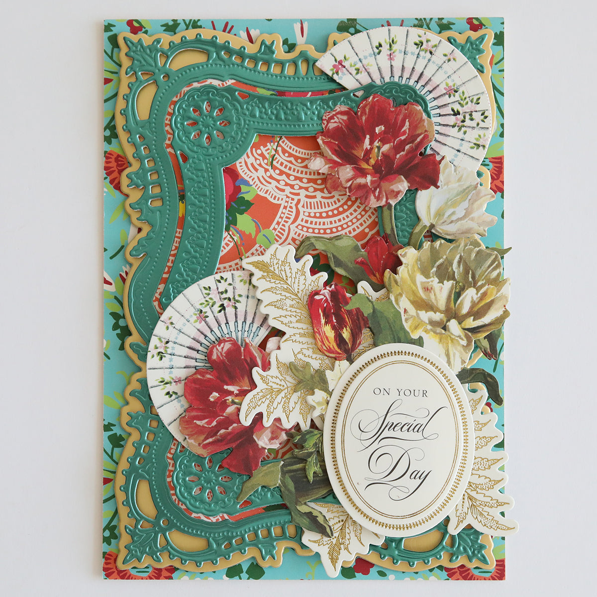 A decorative Hermosa Multi Cultural Cardstock card with ornate green frames, red and white flowers, and paper fans, crafted on fine cardstock. It features a golden oval plaque with the message "On your Special Day", perfectly capturing the essence of Hispanic culture for Hermosa Members Only.