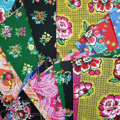 Multiple pieces of **Hermosa Multi Cultural Cardstock** featuring vibrant, intricate floral patterns are layered and arranged together, showcasing a variety of bright colors and designs inspired by Hispanic culture.