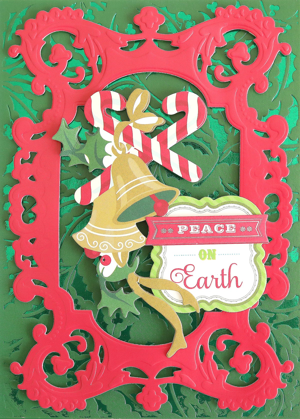 Decorative Christmas card featuring a red ornate frame, candy canes, holly, bell, and a "Peace on Earth" label set against a green embossed background, beautifully crafted on Holiday Coated Cardstock—perfect for foil holiday projects.