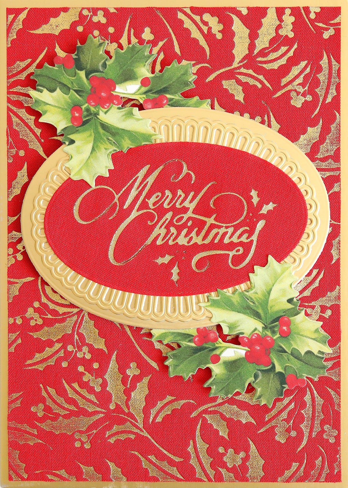Holiday Fabric Card Layers feature a red and gold Christmas card design with "Merry Christmas" in elegant cursive, framed by holly leaves and berries, set against a festive decorative background—perfect for your Christmas card making projects.