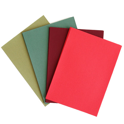 Four hardcover books in olive green, dark green, maroon, and red are stacked and overlapping on a white background, evoking the classic colors of the Holiday Cardstock Bundle—an ideal source of inspiration for Christmas card making or selecting sophisticated scrapbook paper.